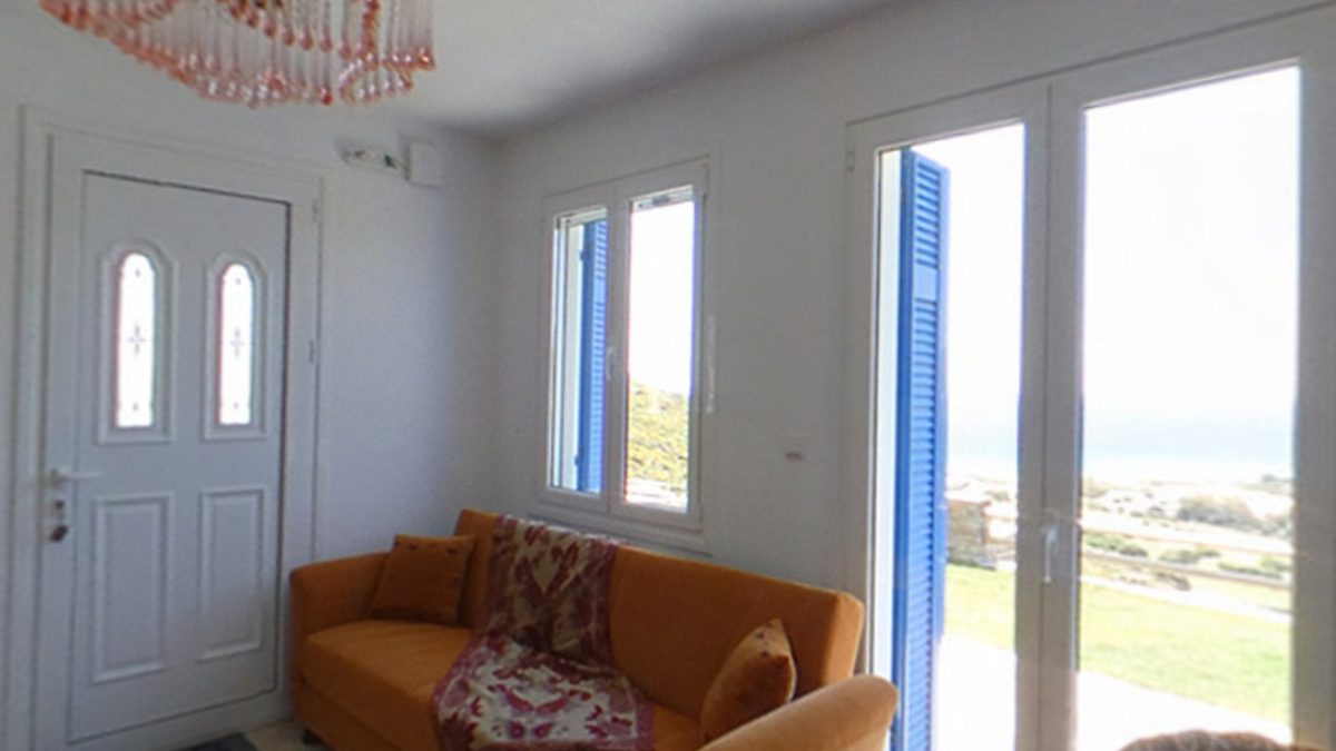 Bright living room opening to sea-view doors