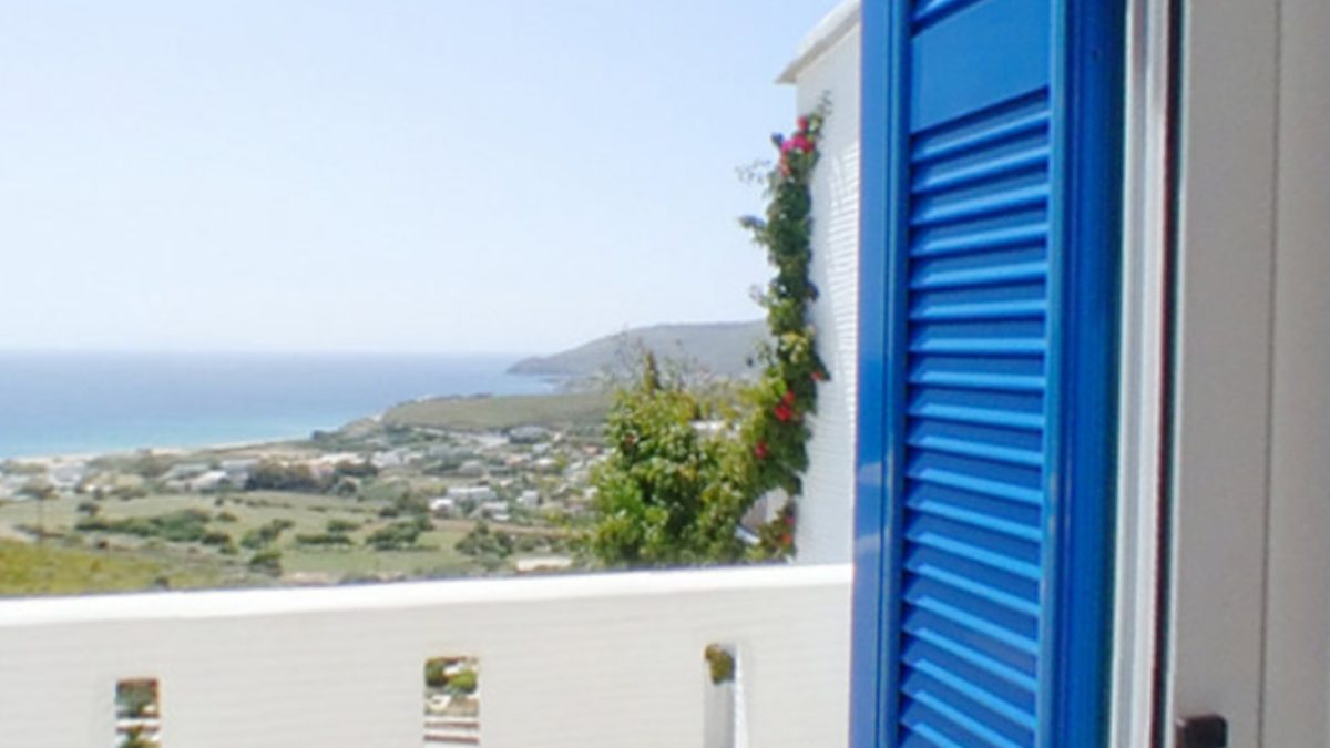 Veranda with blue shutters overlooking the sea